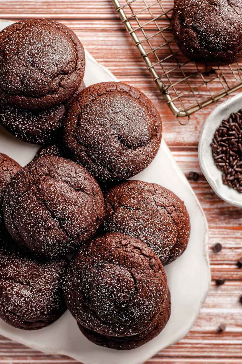 Close-up of Chocolate Lava Cookies with a rich, dark chocolate exterior, some dusted with powdered sugar.
