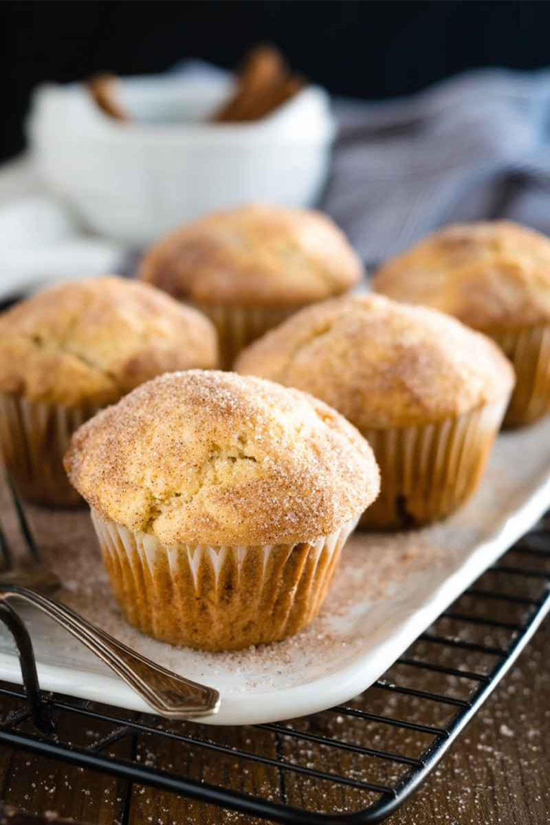 Baked Cinnamon Sugar Muffins cooling on a wire rack, showcasing their golden texture and sweet topping.