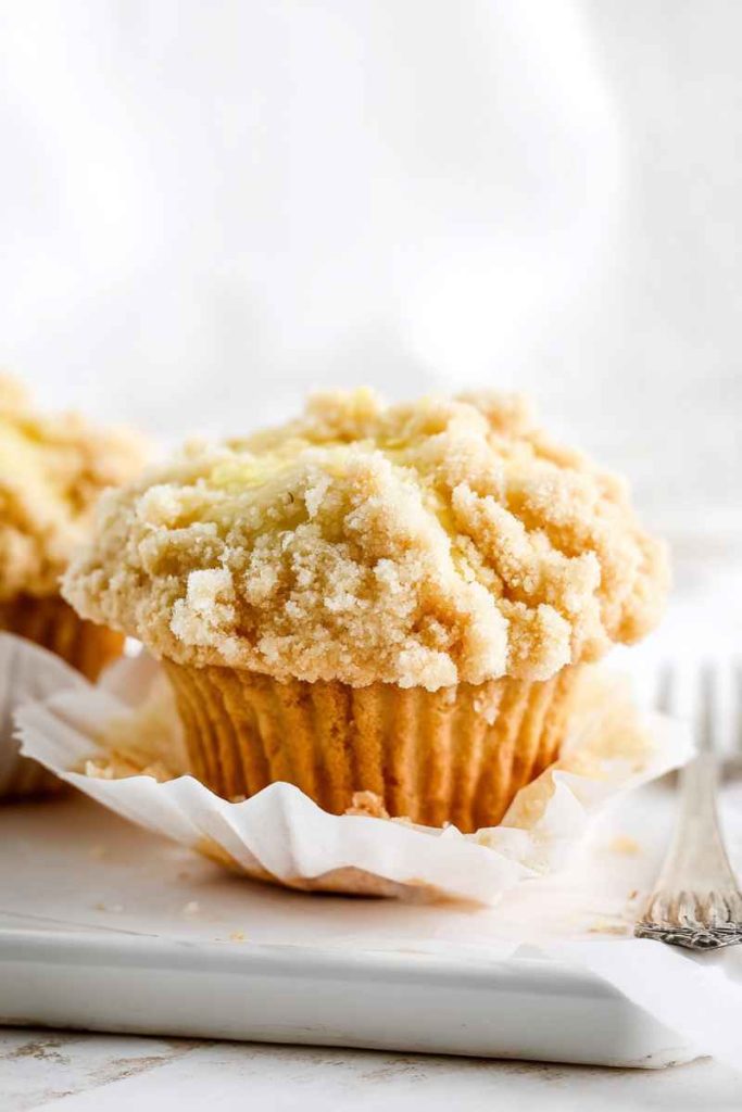 Golden-yellow lemon muffin topped with a crumbly streusel.