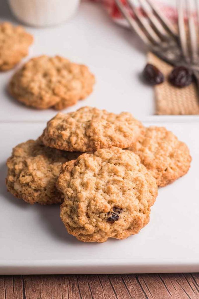 A plate of Nana's Oatmeal Cookies with golden-brown texture, visible oats, and raisins.