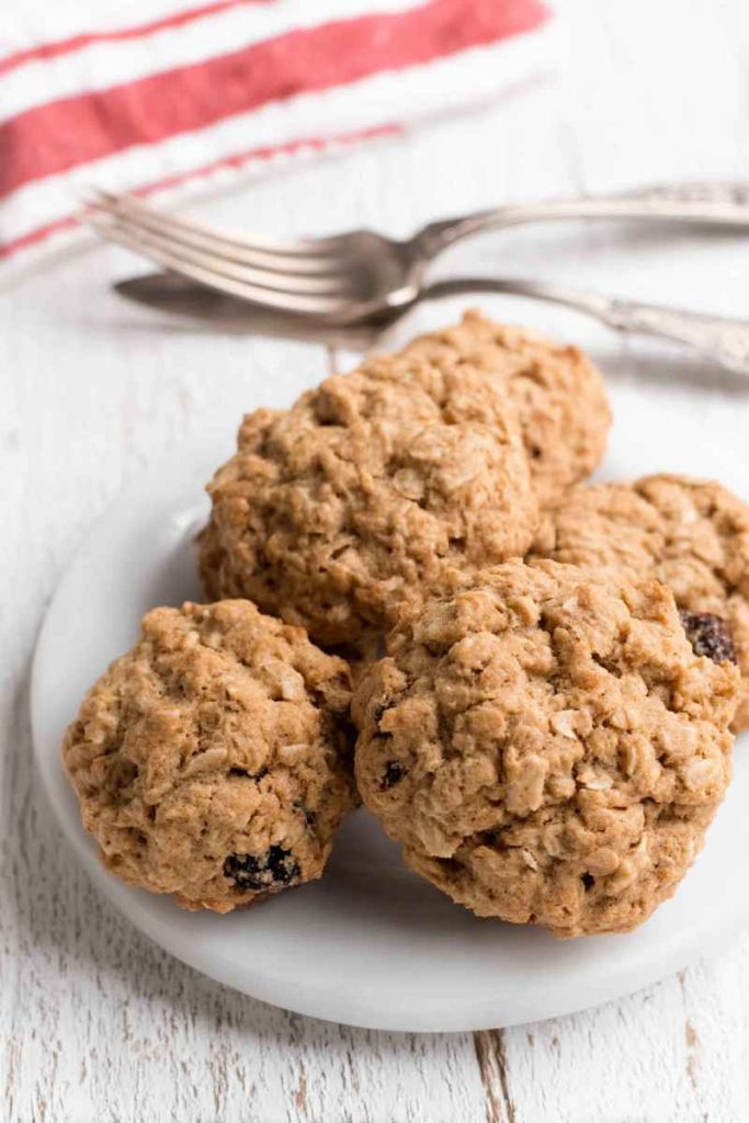 Close-up of Nana's Oatmeal Cookies with golden-brown texture, oats, and raisins.