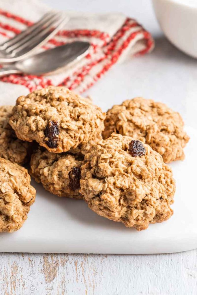 A stack of Nana's Oatmeal Cookies with golden-brown texture, oats, and raisins.