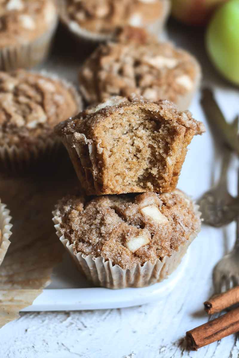 Cross-section of a Sourdough Apple Cinnamon Muffin showing its moist interior with apple chunks and a crumbly topping.