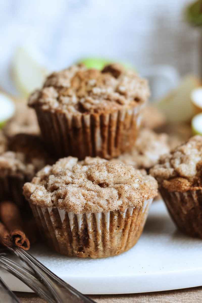 Golden-brown Sourdough Apple Cinnamon Muffins topped with a sweet crumb mixture, ready to be enjoyed.