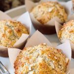Golden Bakery-Style Almond Poppy Seed Muffins topped with sliced almonds and poppy seeds, ready to be enjoyed.
