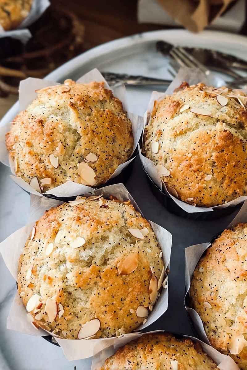 Delicious Almond Poppy Seed Muffins with a golden crust and almond streusel topping.