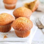 Plump brown sugar muffins dusted with cinnamon sugar, ready to be enjoyed.