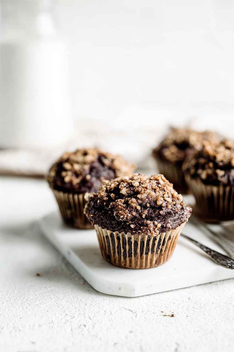 Moist Chocolate Coffee Muffins topped with a crunchy toffee streusel, placed on a marble tray.