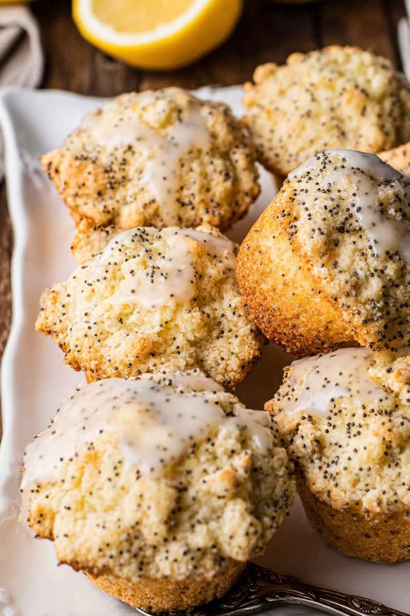 Lemon Poppy Seed Muffins with a generous layer of crumbly streusel topping, served on a white plate.
